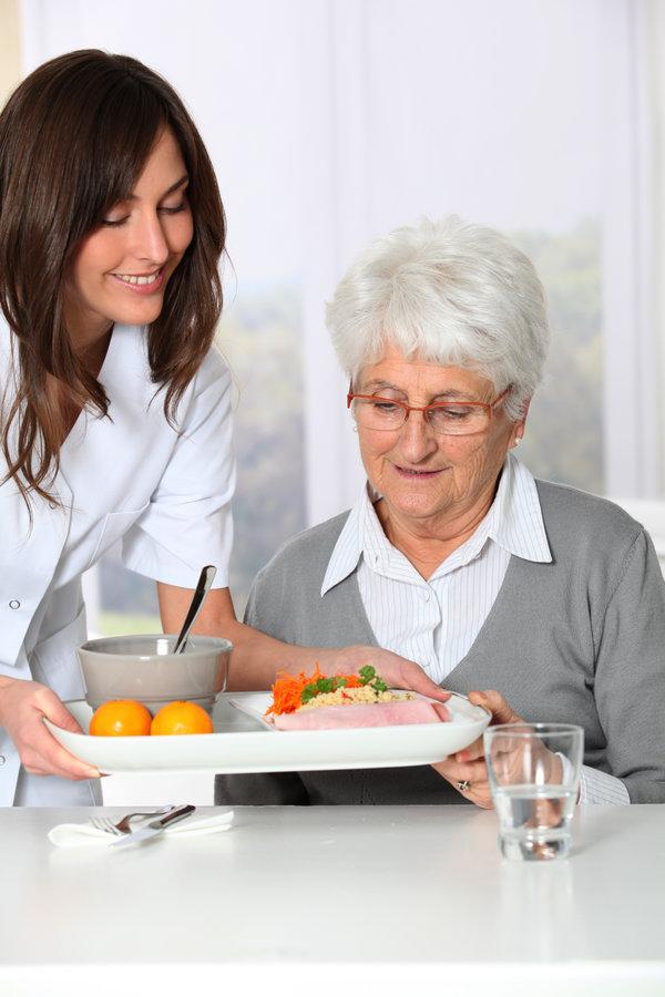 caring for an elderly woman during lunch